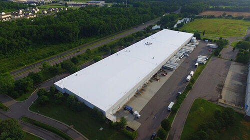 Aerial view of a large industrial distribution warehouse roof