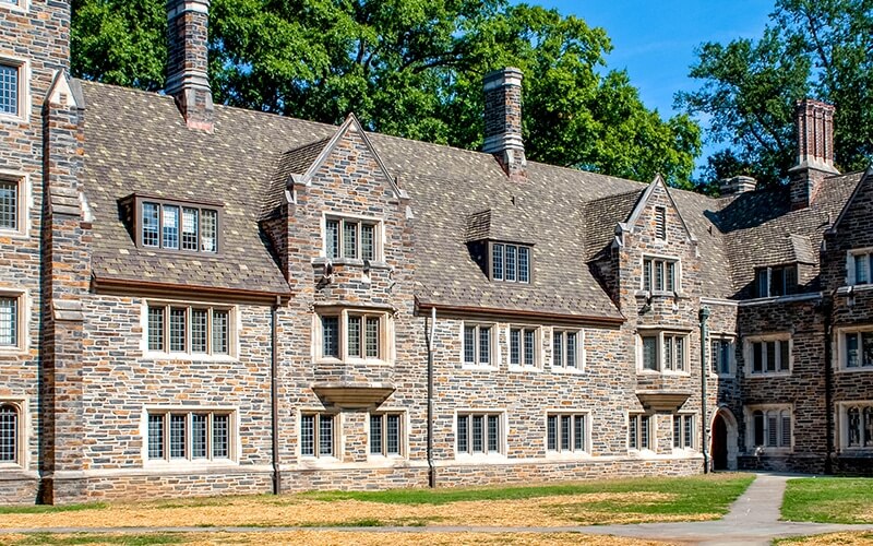 Historic stone and clay tile roof dorm building on Duke University's campus