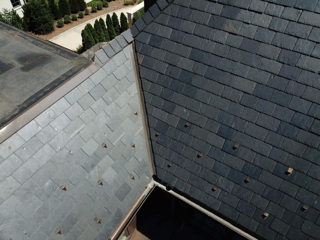 aerial close up of a black and grey slate tile roof