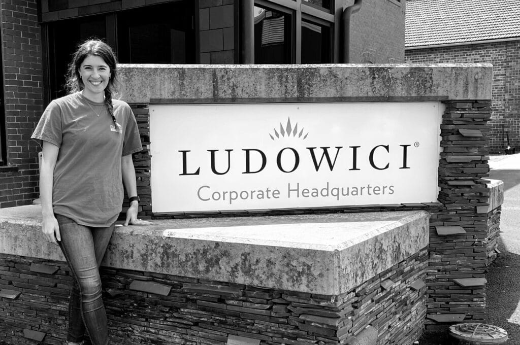 brc employee standing outside the ludowici headquarters with their sign