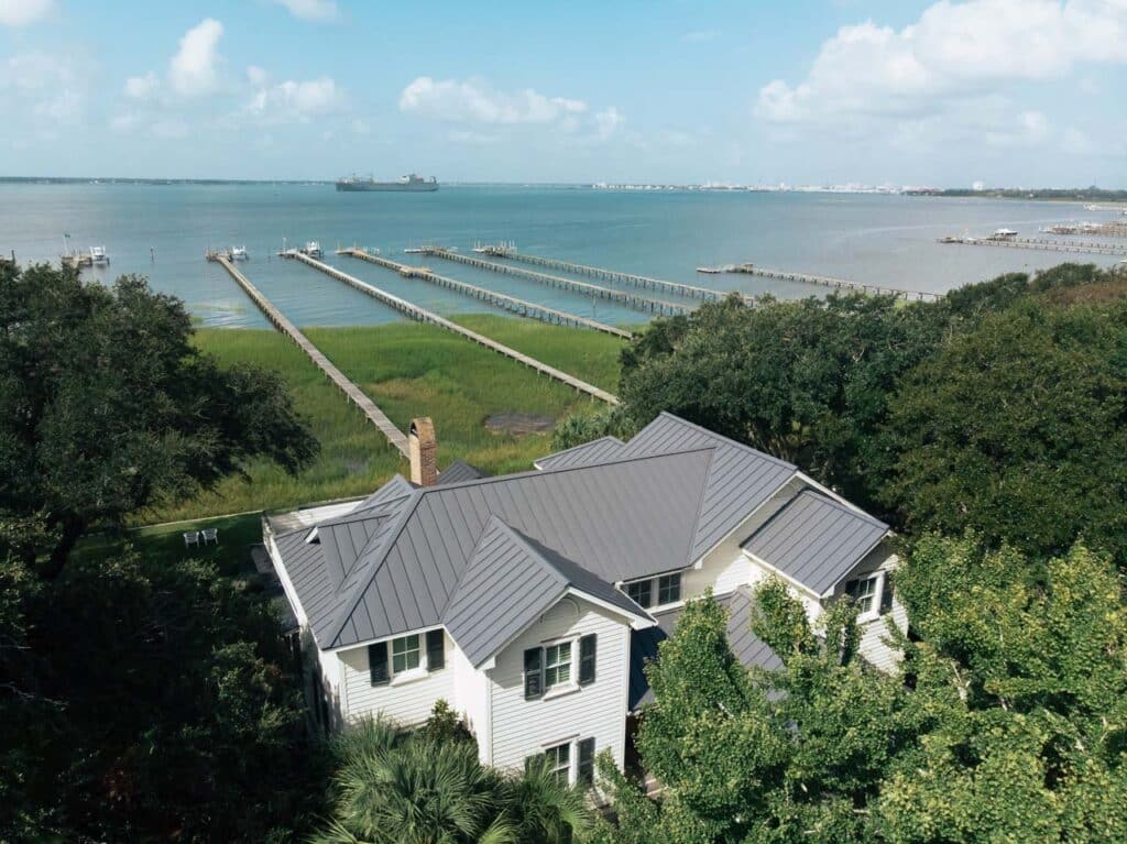 Aerial view of a gray metal roof on a waterfront house