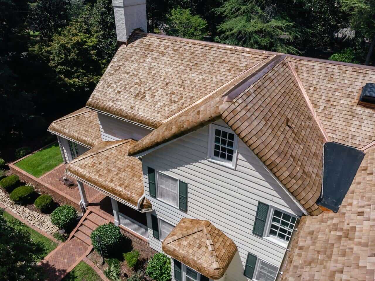 Aerial view of a new cedar shake roof with copper details