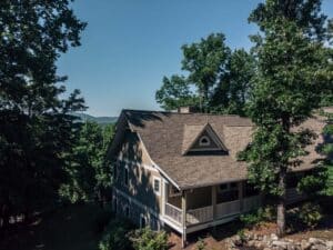 Aerial view of house in the NC mountains with a brown shingle roof