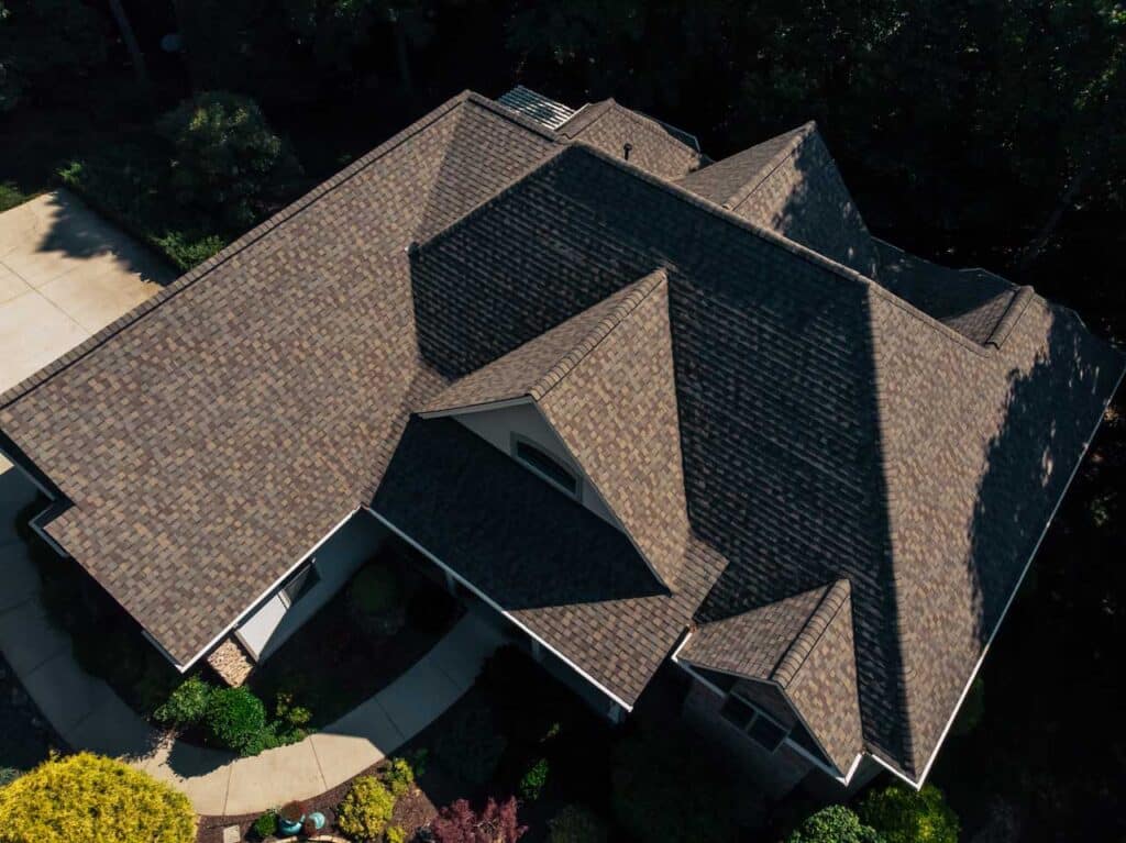 Aerial view of a house with brown roof