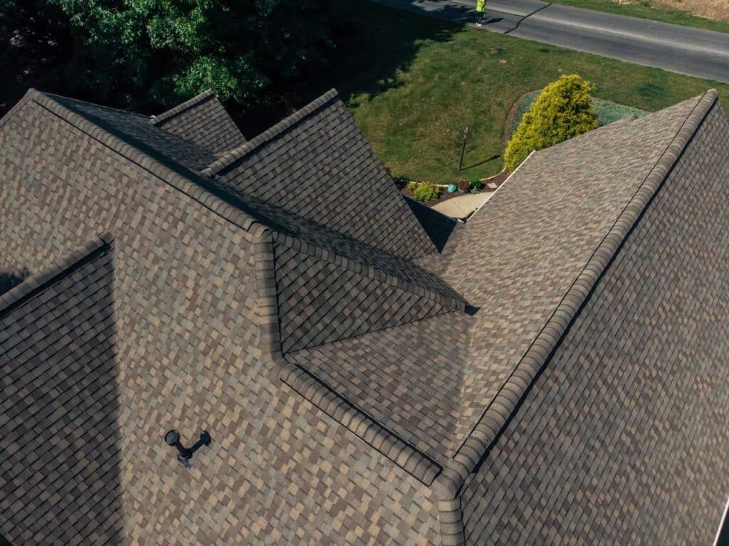 Aerial view of a house with brown roof