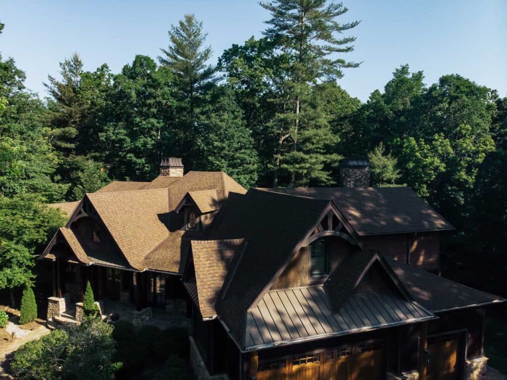 Aerial view of brown shingle roof surrounded by trees