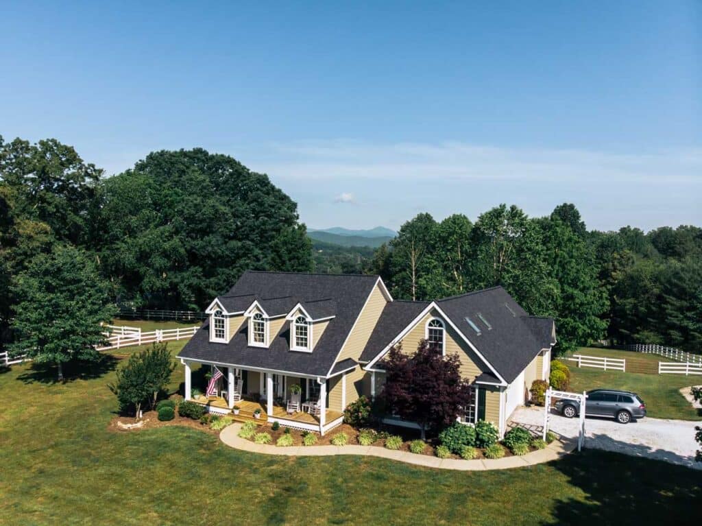 Aerial view of a house in the NC mountains with a black roof