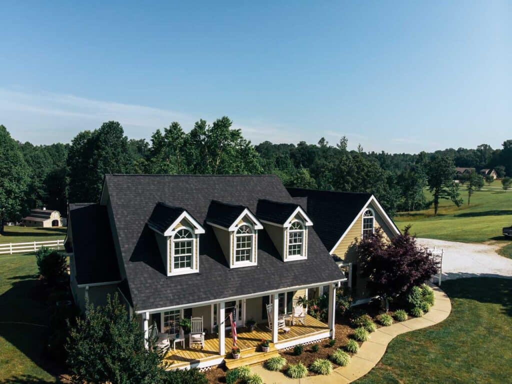 Aerial view of a house in the NC mountains with a black roof