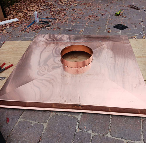 Baker Roofing Company fabricated copper chimney cap ready to be installed.