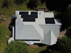 White gray shingle roof with solar panels