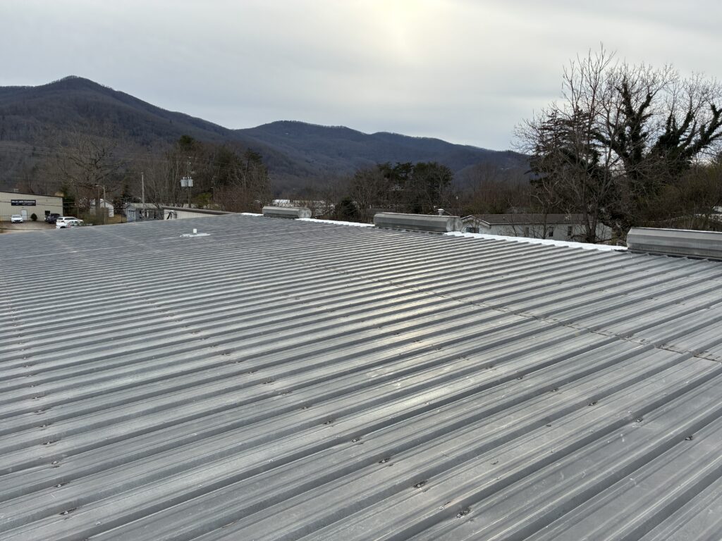 Metal roof restoration on warehouse