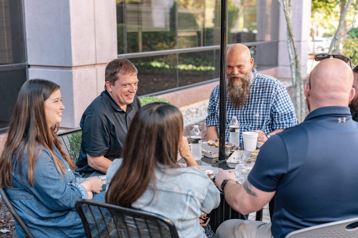 group of employees sitting outside