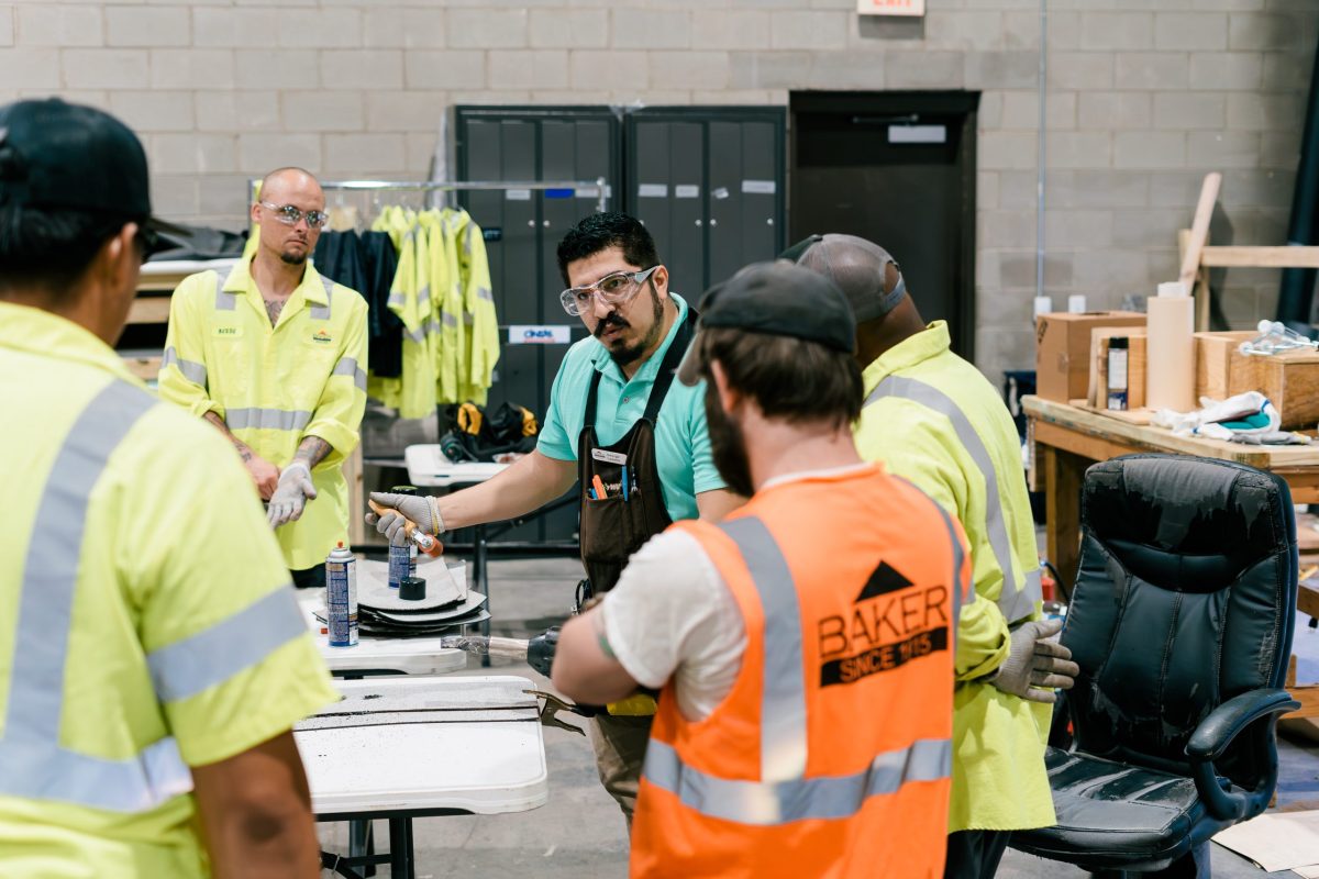 baker roofing trainer teaching a of field employees new roofing techniques