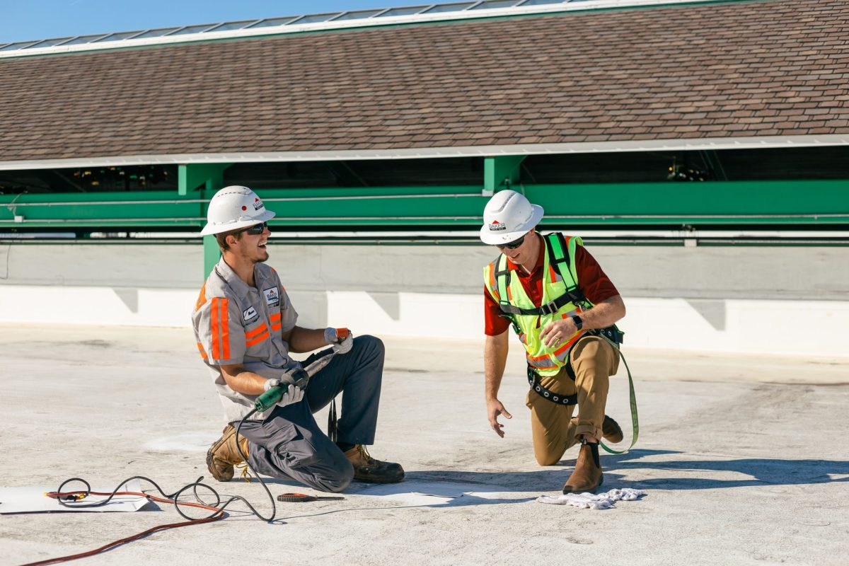 two guys working on roof