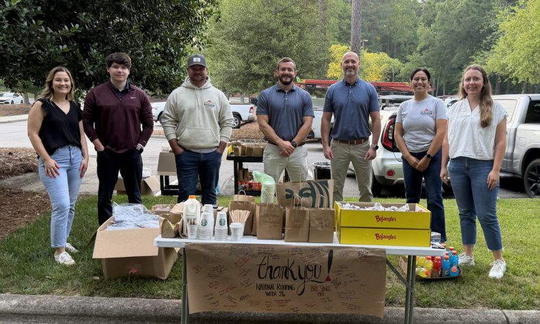 hr and recruiting team smiling with breakfast for field team