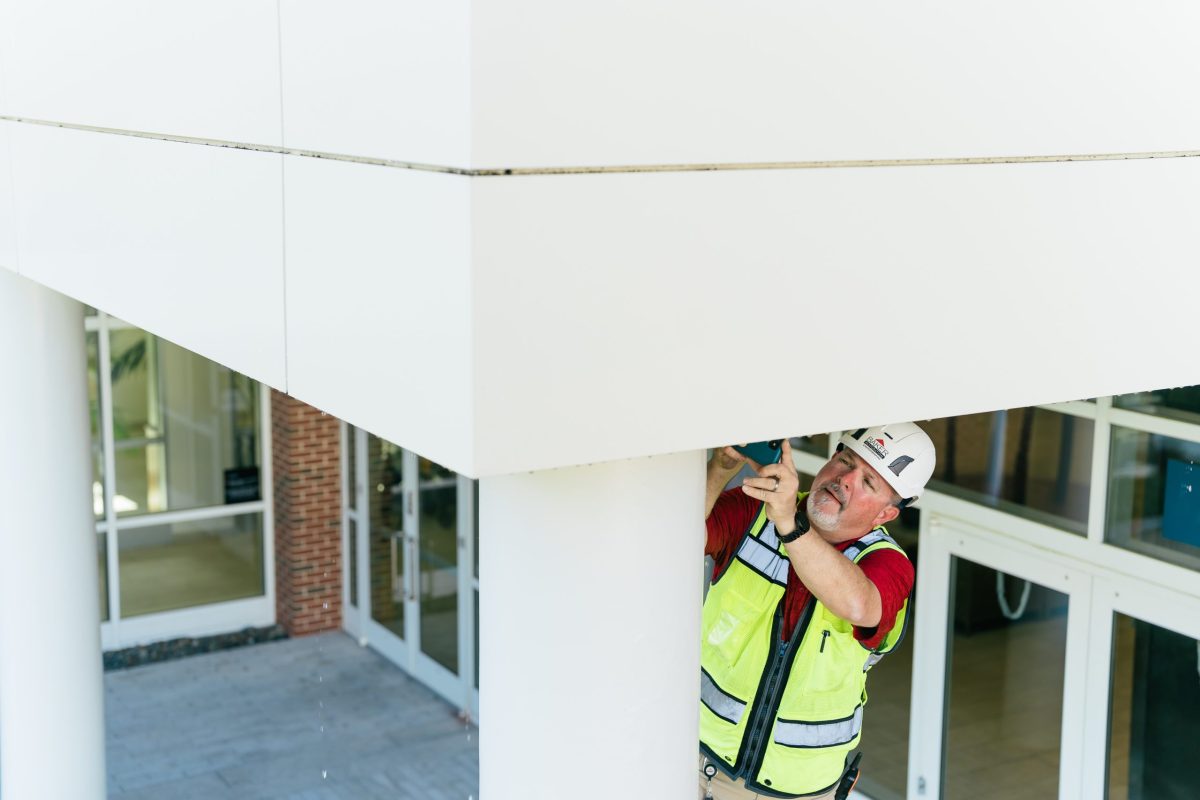 man inspecting concrete building