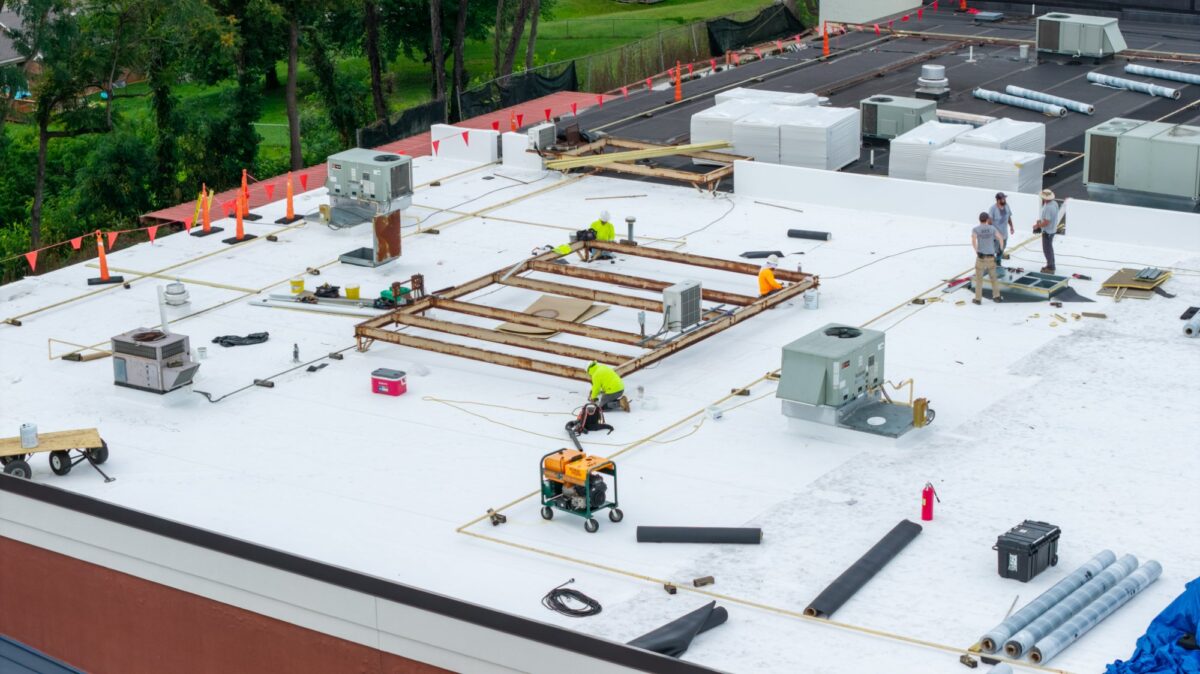 Baker Roofing crew installing a 60 mil TPO roof recover on the Boot Barn store in Lynchburg, VA