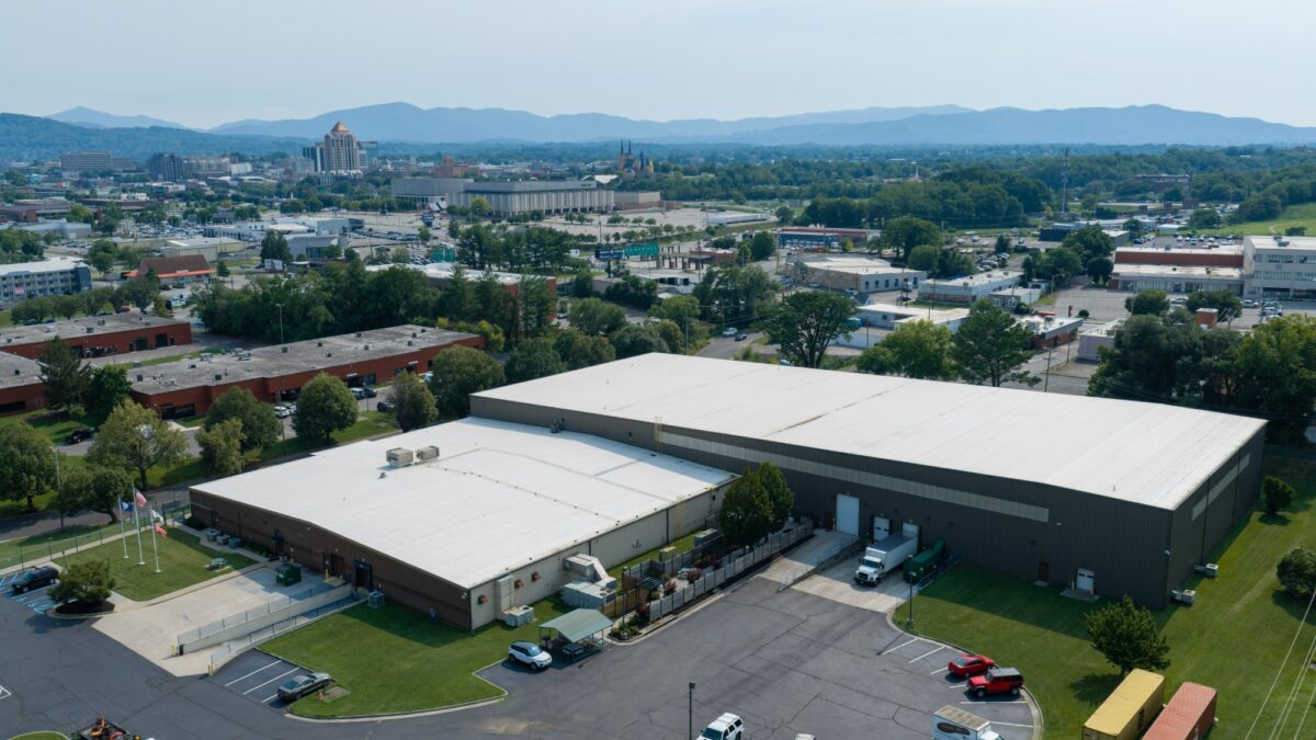 Aerial view of the white TPO roof on Foot Levelers' manufacturing facility in Roanoke, VA, with the Blue Ridge Mountains behind
